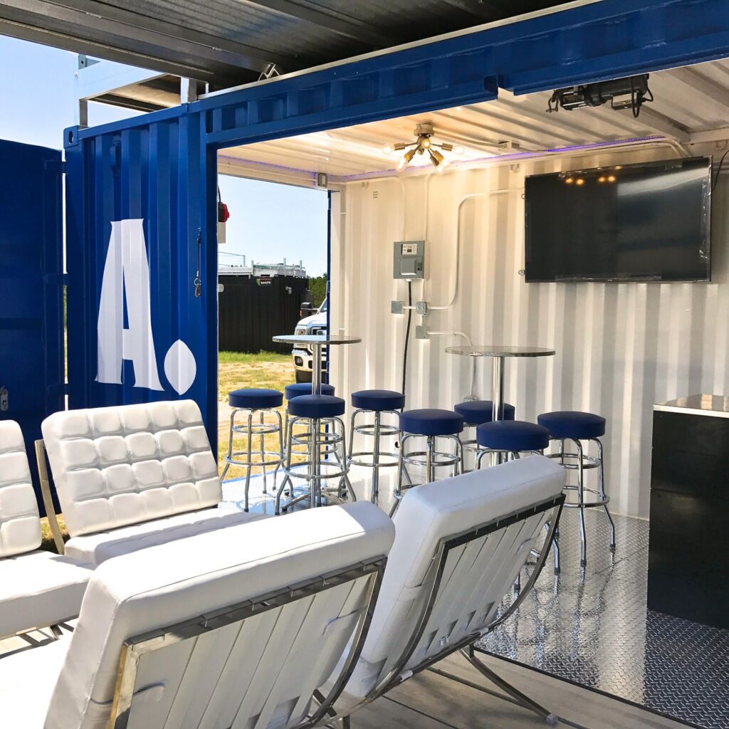 A room with white furniture and blue chairs.