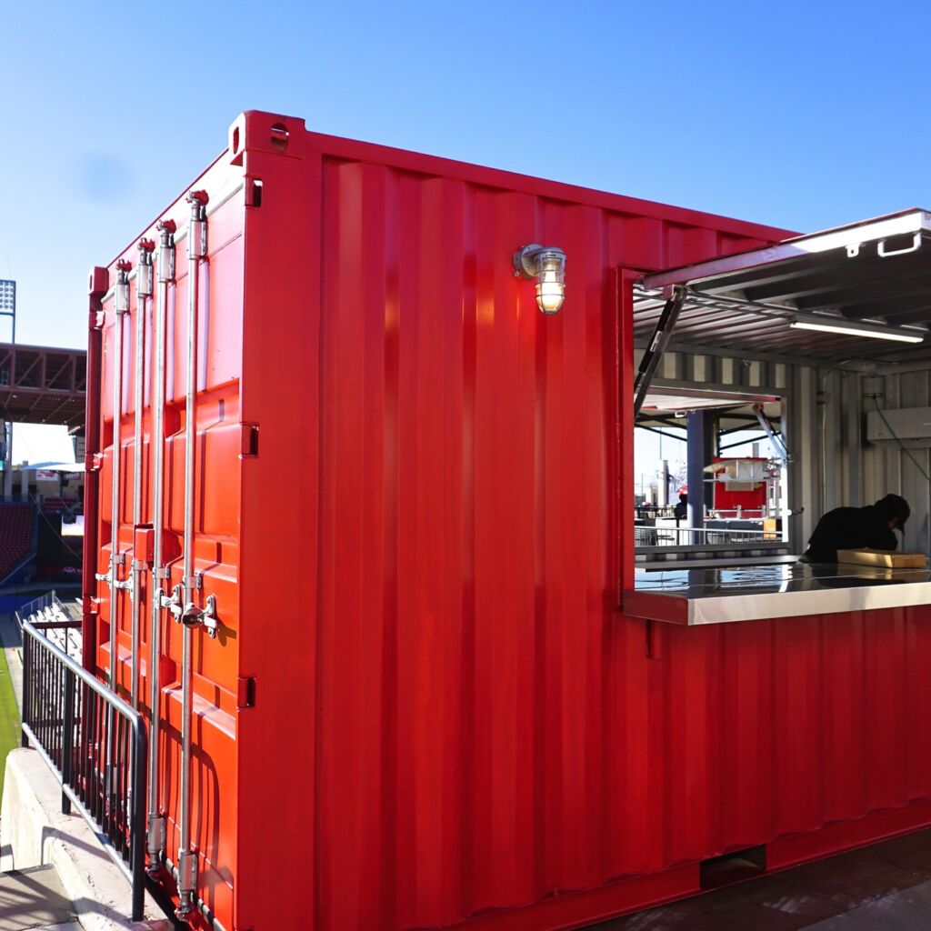 A red container with a counter and food inside of it.
