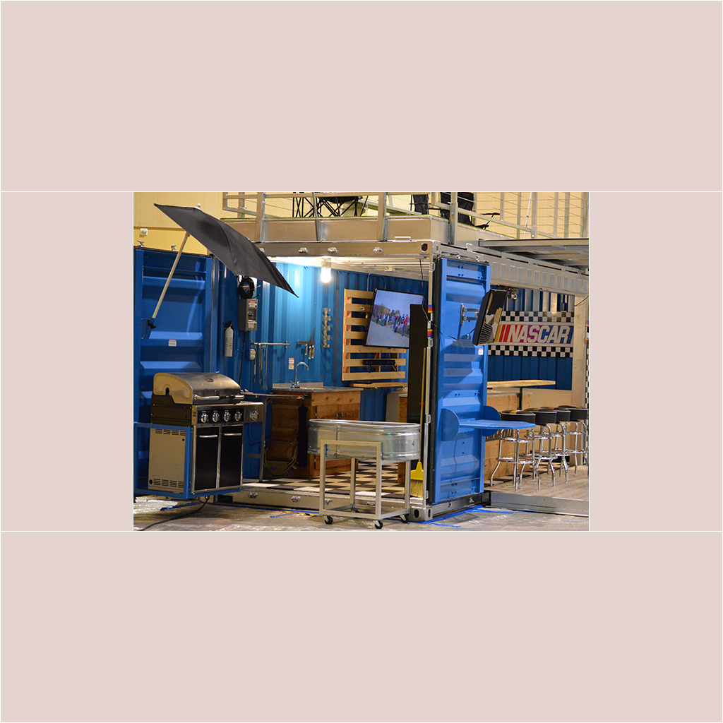 A blue container with an umbrella on top of it.