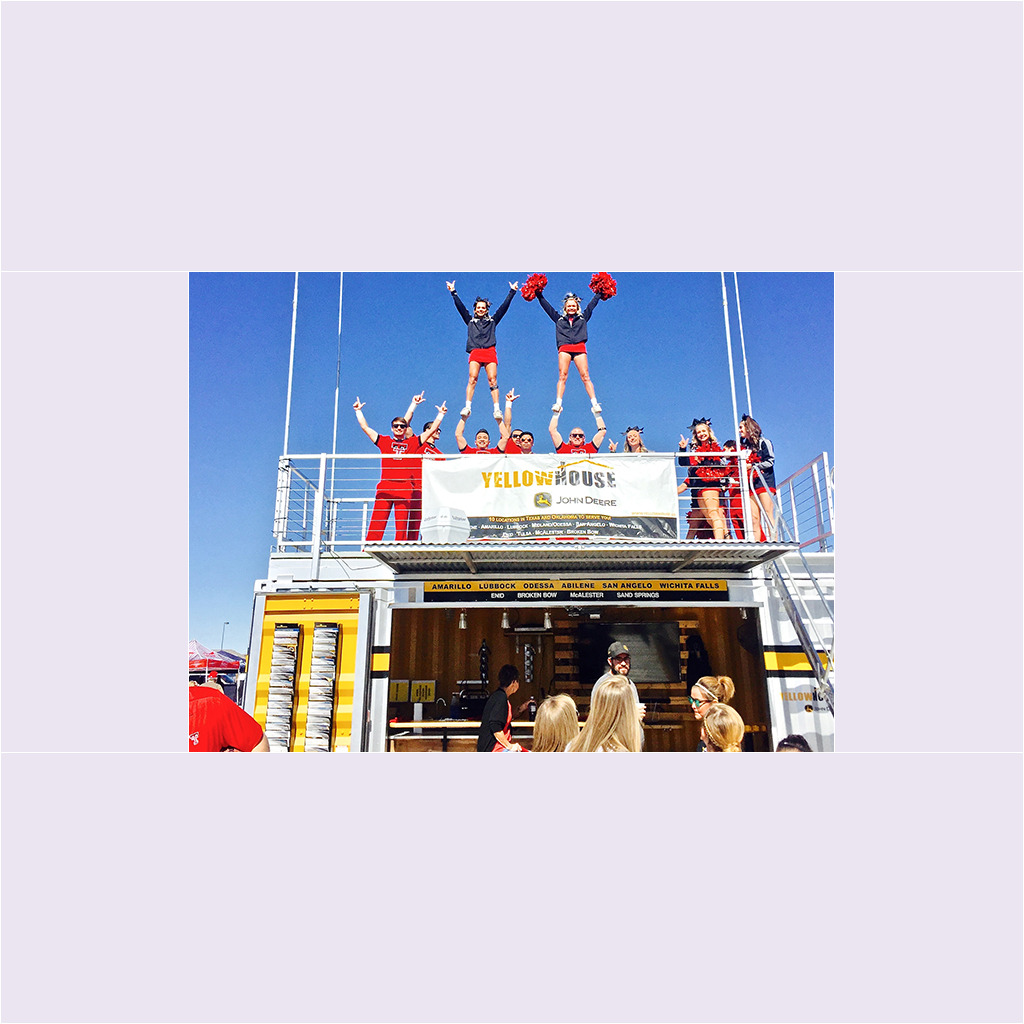A group of cheerleaders standing on top of a building.