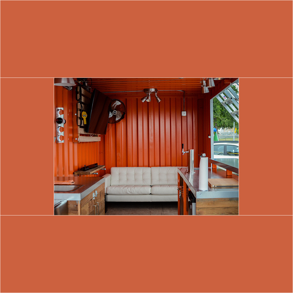 A room with a couch and a fan in it