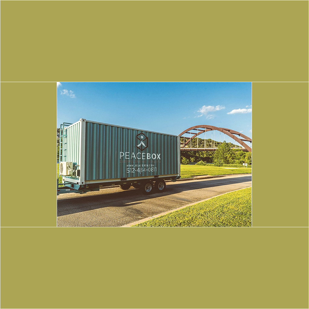 A truck driving down the road near a bridge.