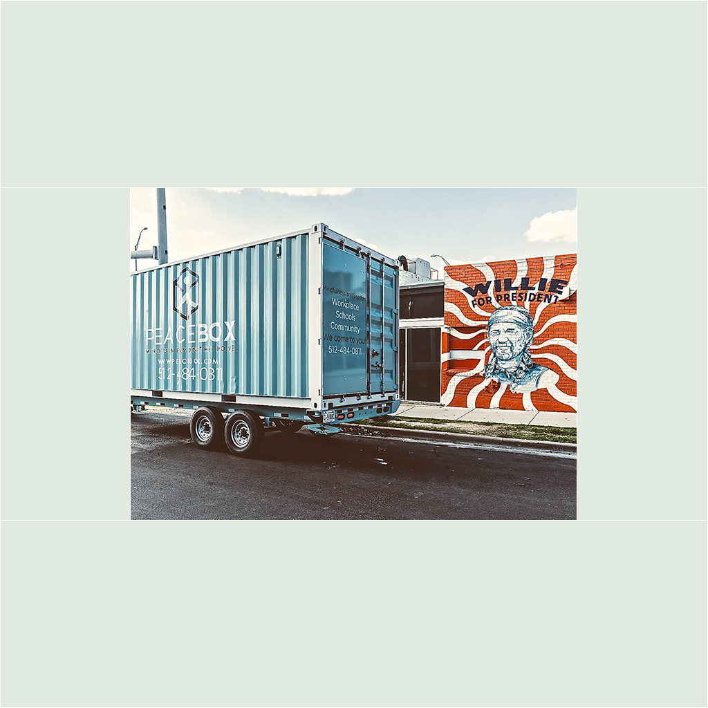 A truck is parked in front of a building.