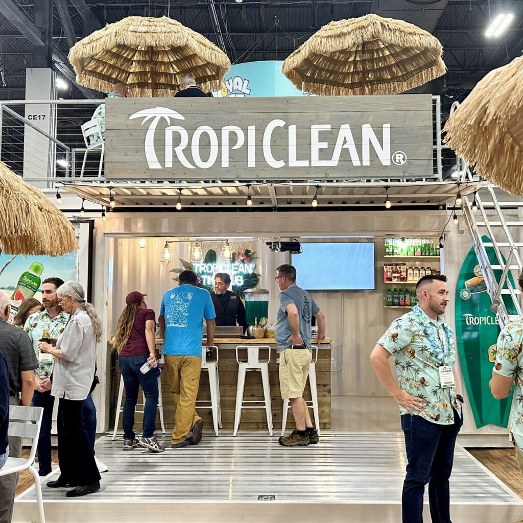 A group of people standing around at tropiclean.