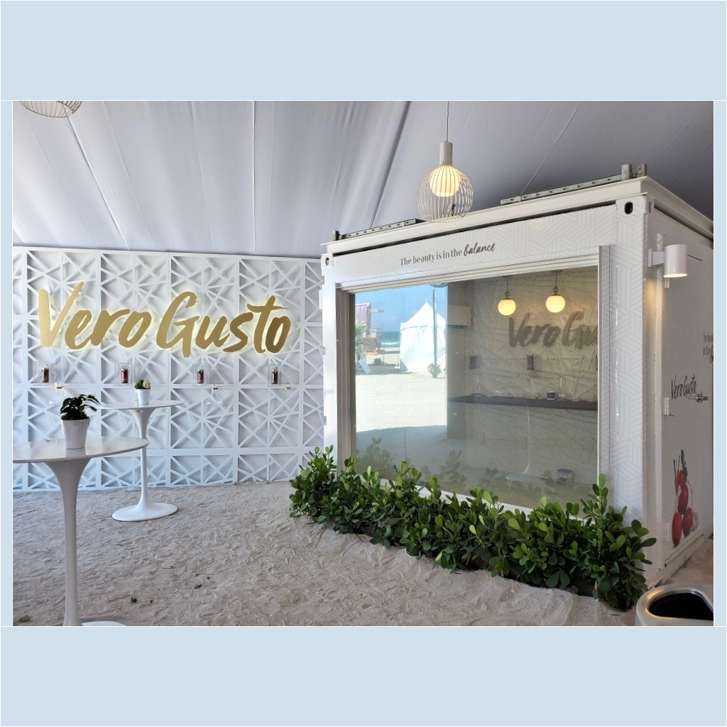 A white booth with plants growing in it.