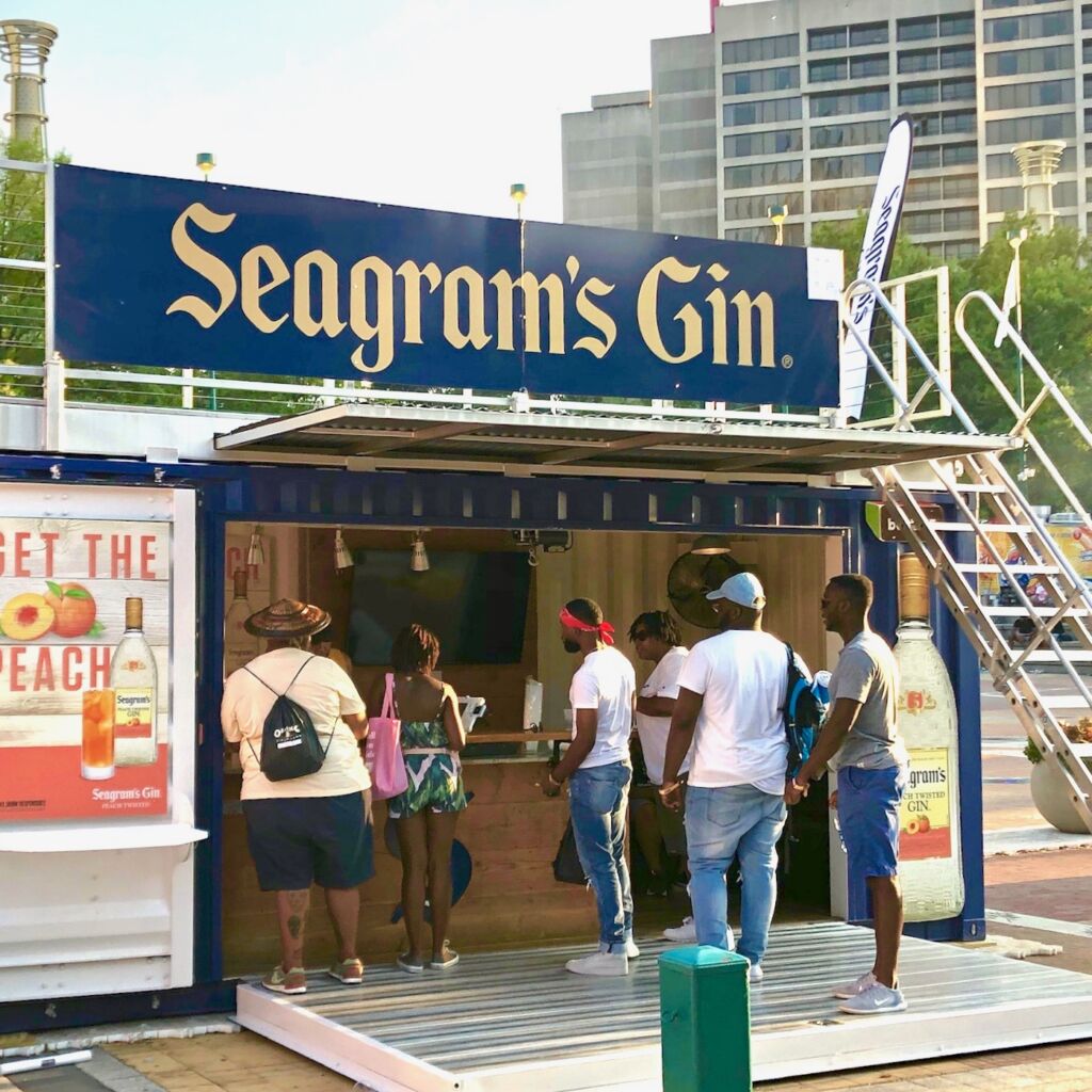 A group of people standing around a booth.