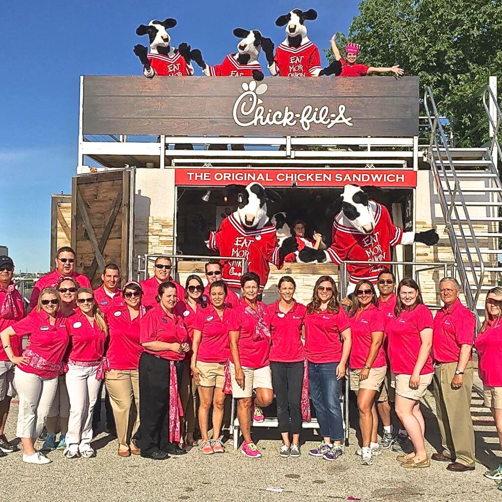 A group of people standing in front of a truck.