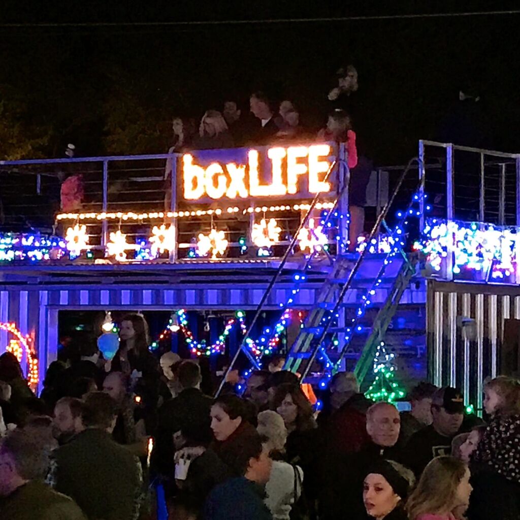 A crowd of people standing on top of a building.