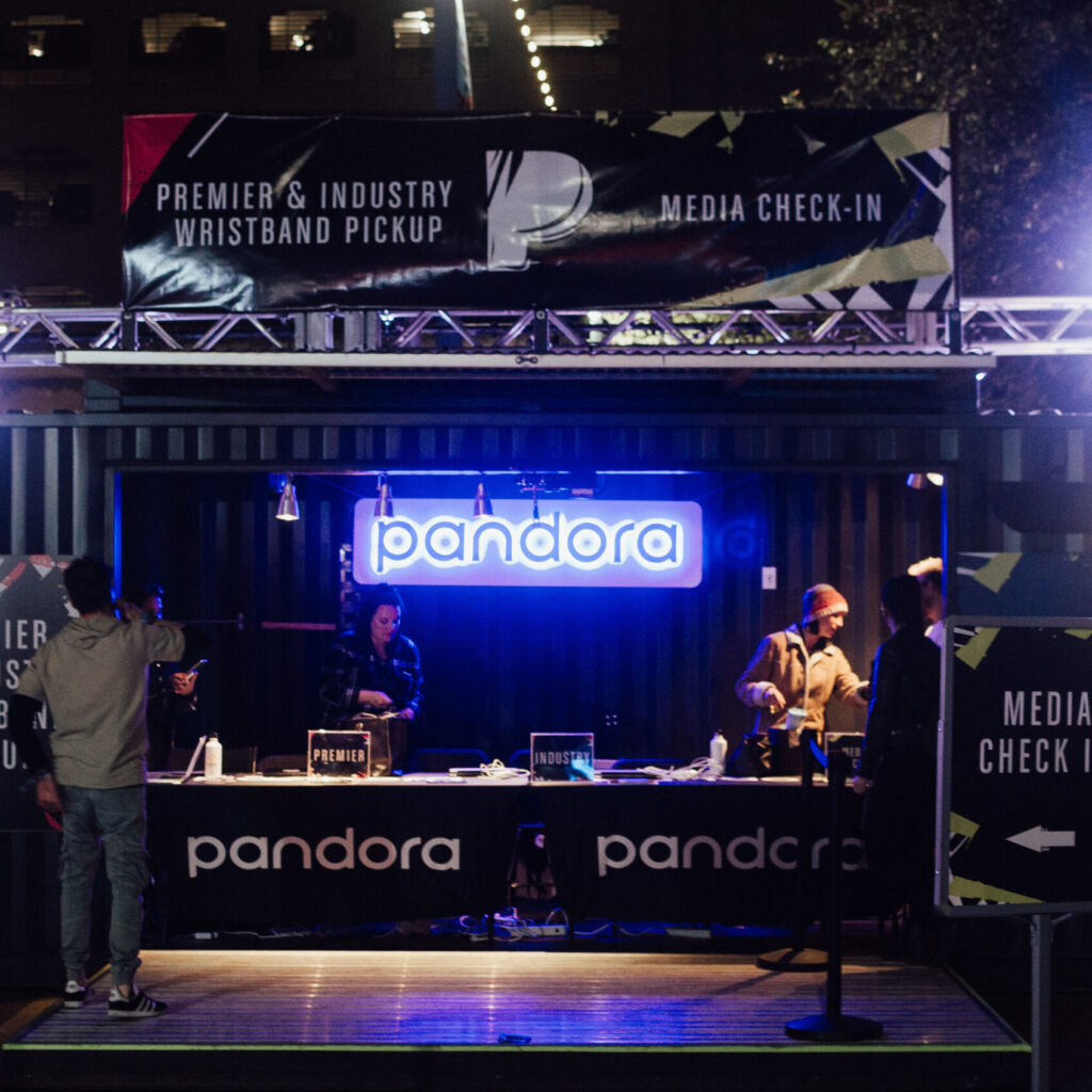 A stage with people standing around it and lights