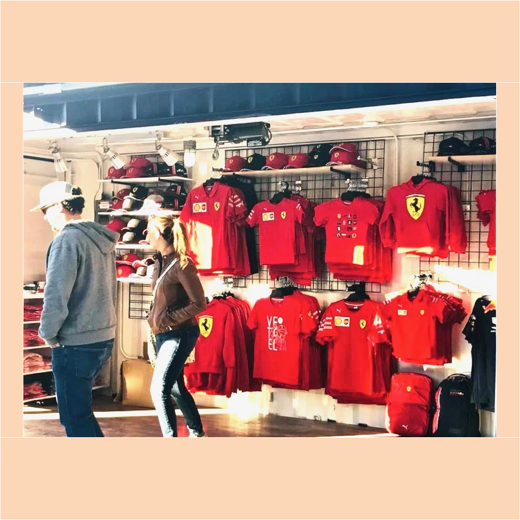 A couple of people that are standing in front of some shirts