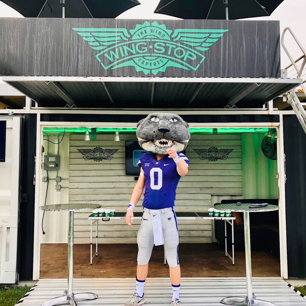 A man holding onto a frisbee in front of an eagle.