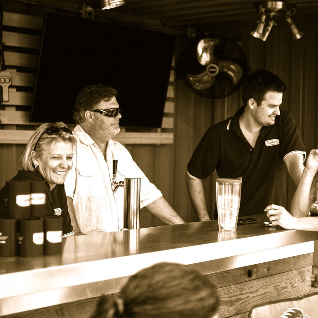 A group of people sitting at the bar