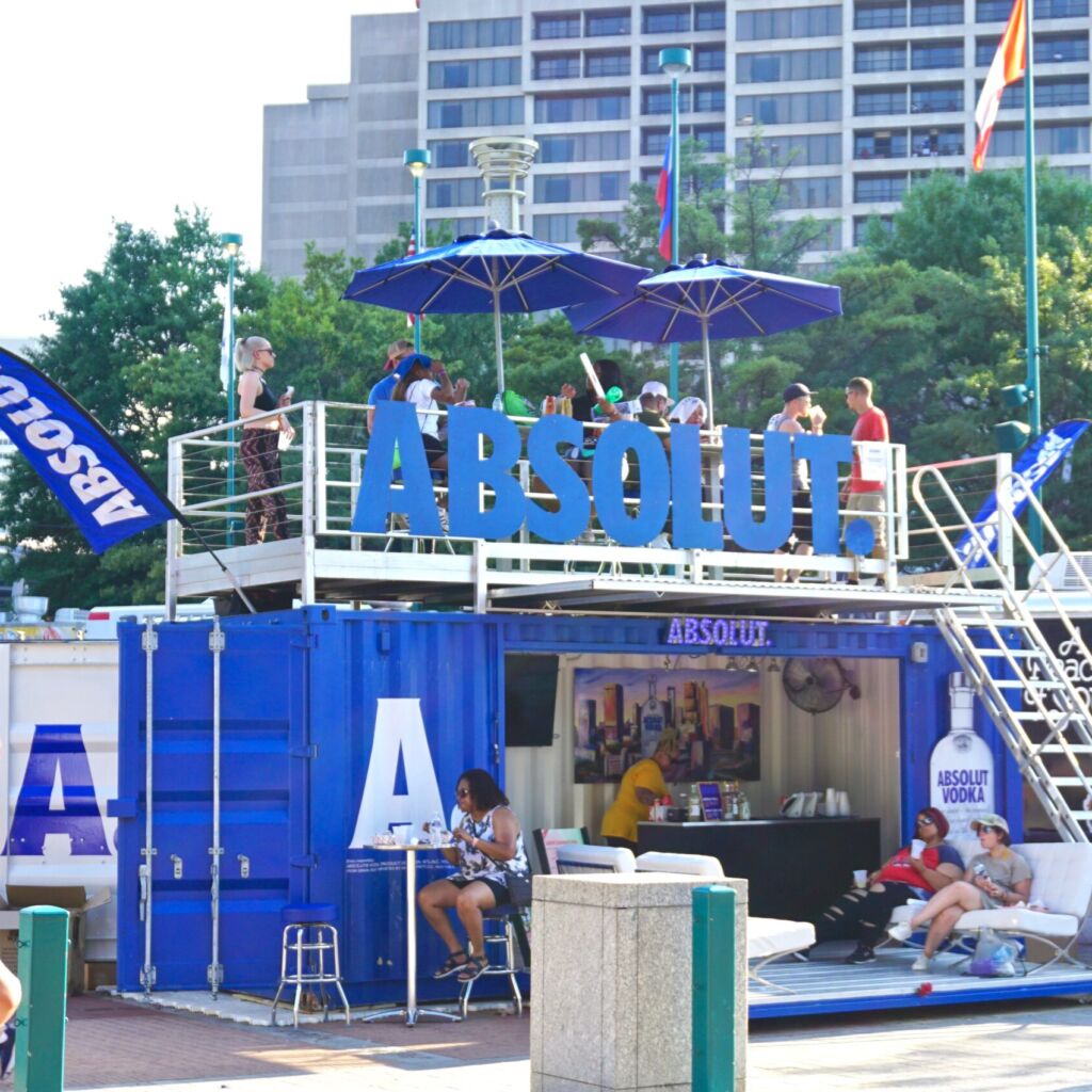 A group of people sitting on top of an open deck.