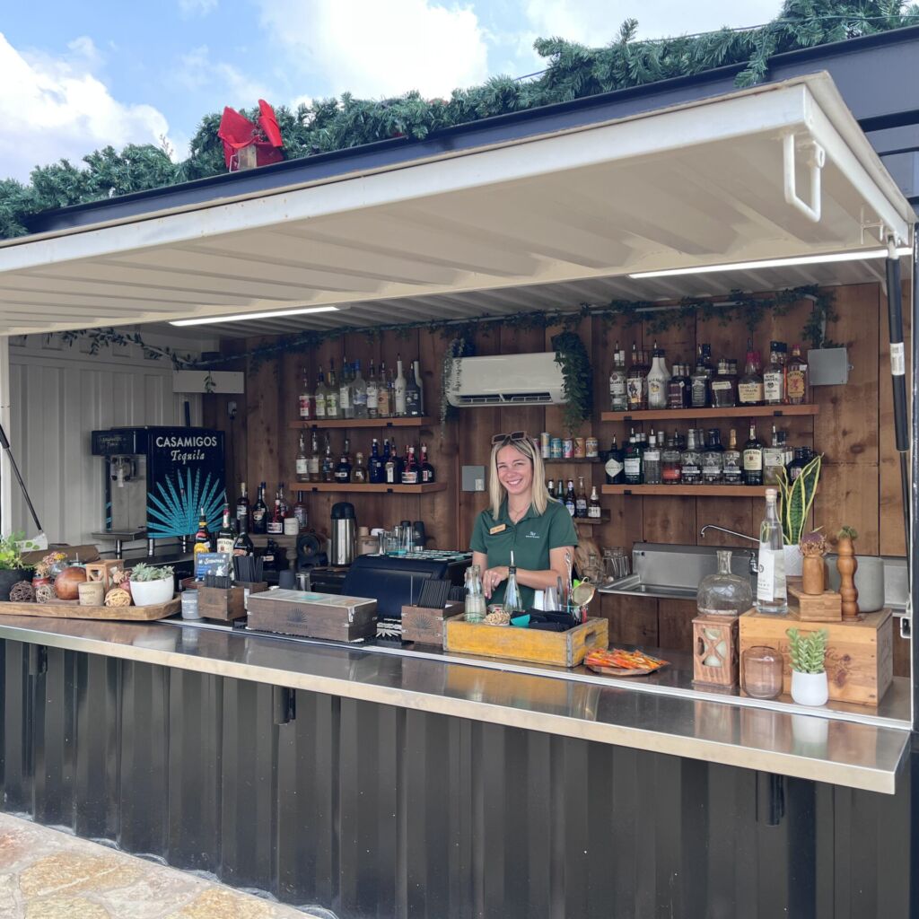 A bar with many bottles of alcohol on the counter