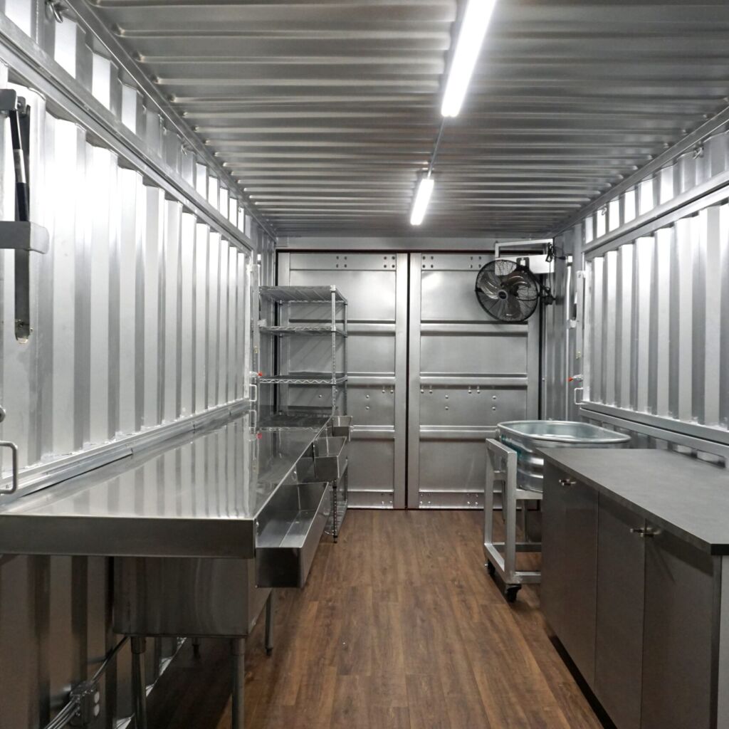 A kitchen with stainless steel counters and cabinets.