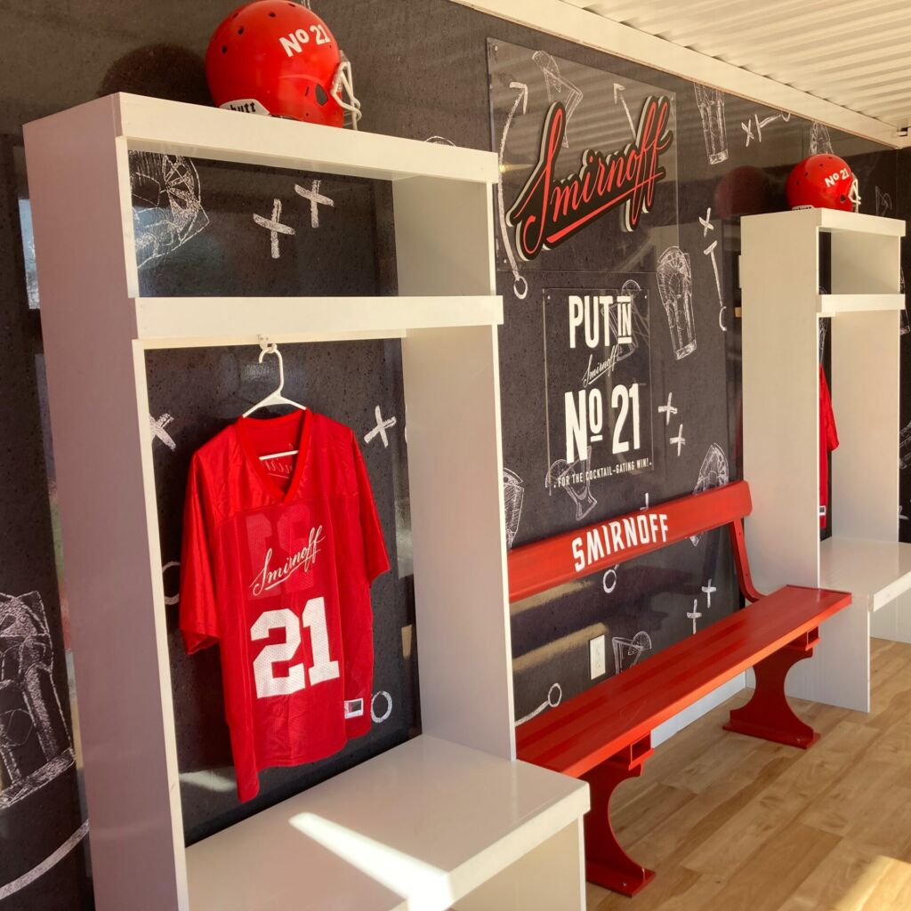 A room with a bench and a wall of football memorabilia.